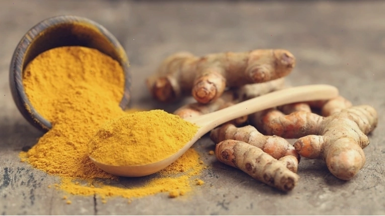 Bột nghệ vàng óng trong bát nhỏ, sẵn sàng để thêm vào công thức nấu cà ri