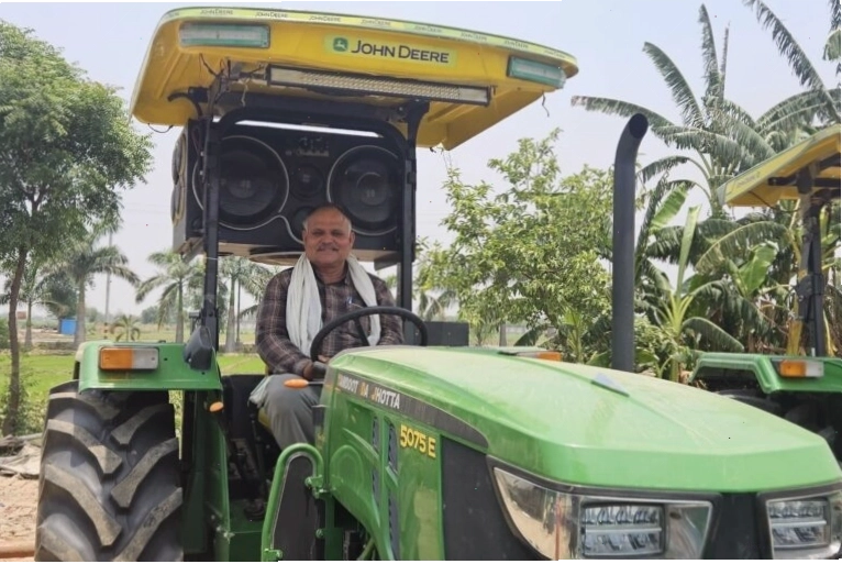 A farmer using the Kisan Suvidha app on a smartphone for weather data