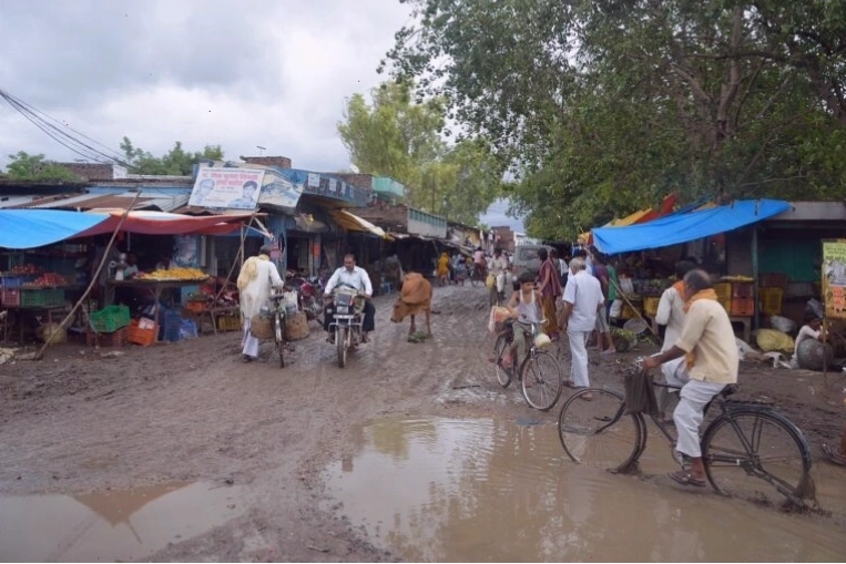 Farmers discussing weather patterns in a rural Indian setting